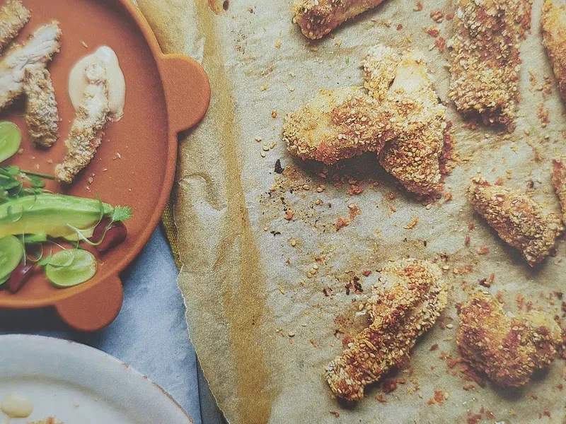 Sesame-crusted chicken bites with tahini yoghurt dip